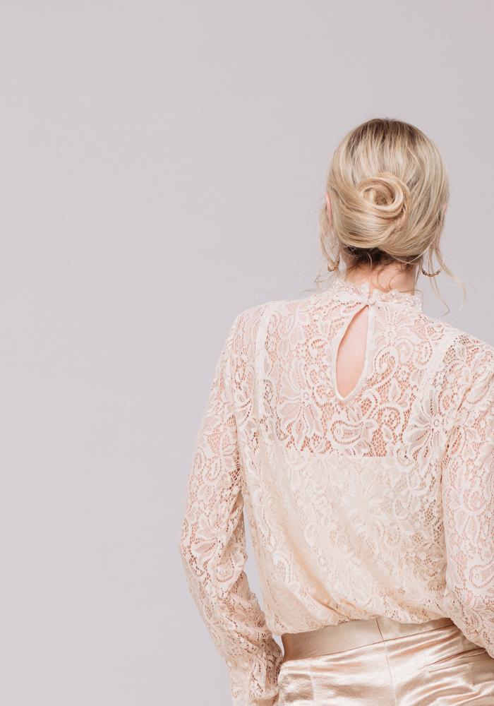 A stylish Women's Lace Turtle Neck Top featuring sheer lace fabric and a high neck design, perfect for layering and holiday outfits.