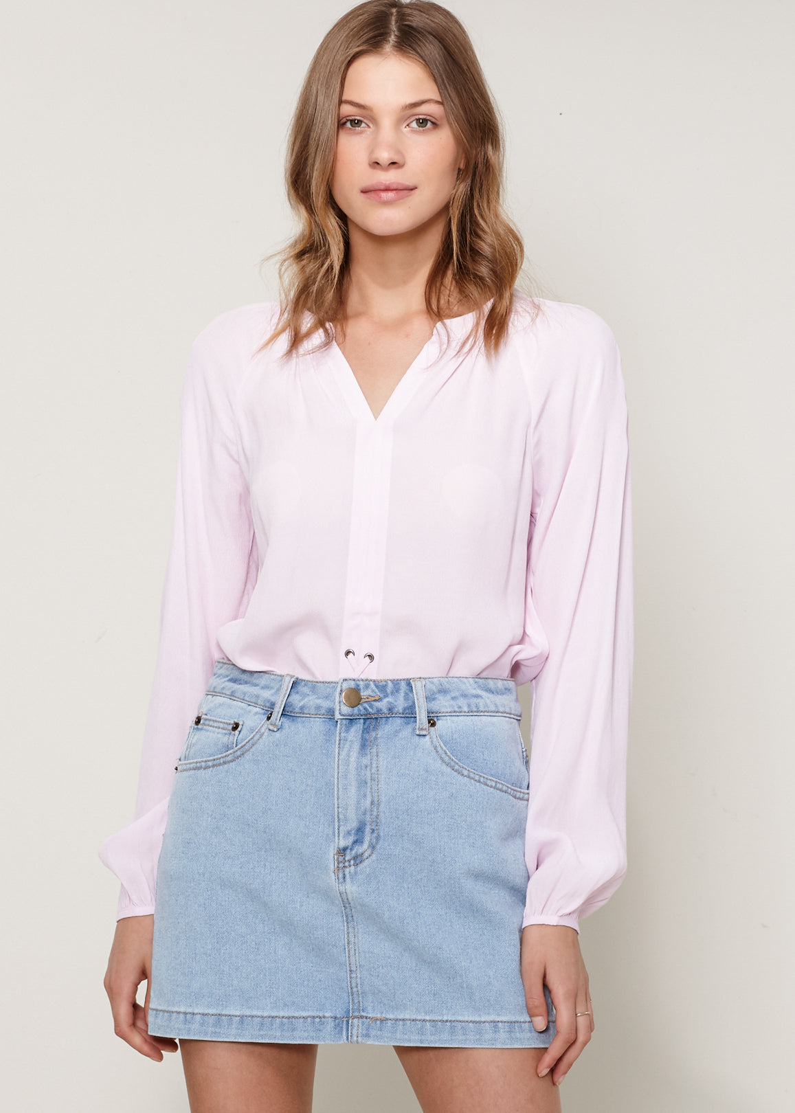 A stylish Women's Lace Up Blouse featuring a round split neck, self-tie lace-up front, and long sleeves with gathered cuffs, made from 100% viscose.