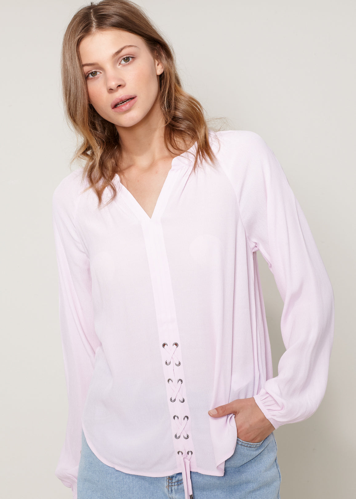 A stylish Women's Lace Up Blouse featuring a round split neck, self-tie lace-up front, and long sleeves with gathered cuffs, made from 100% viscose.