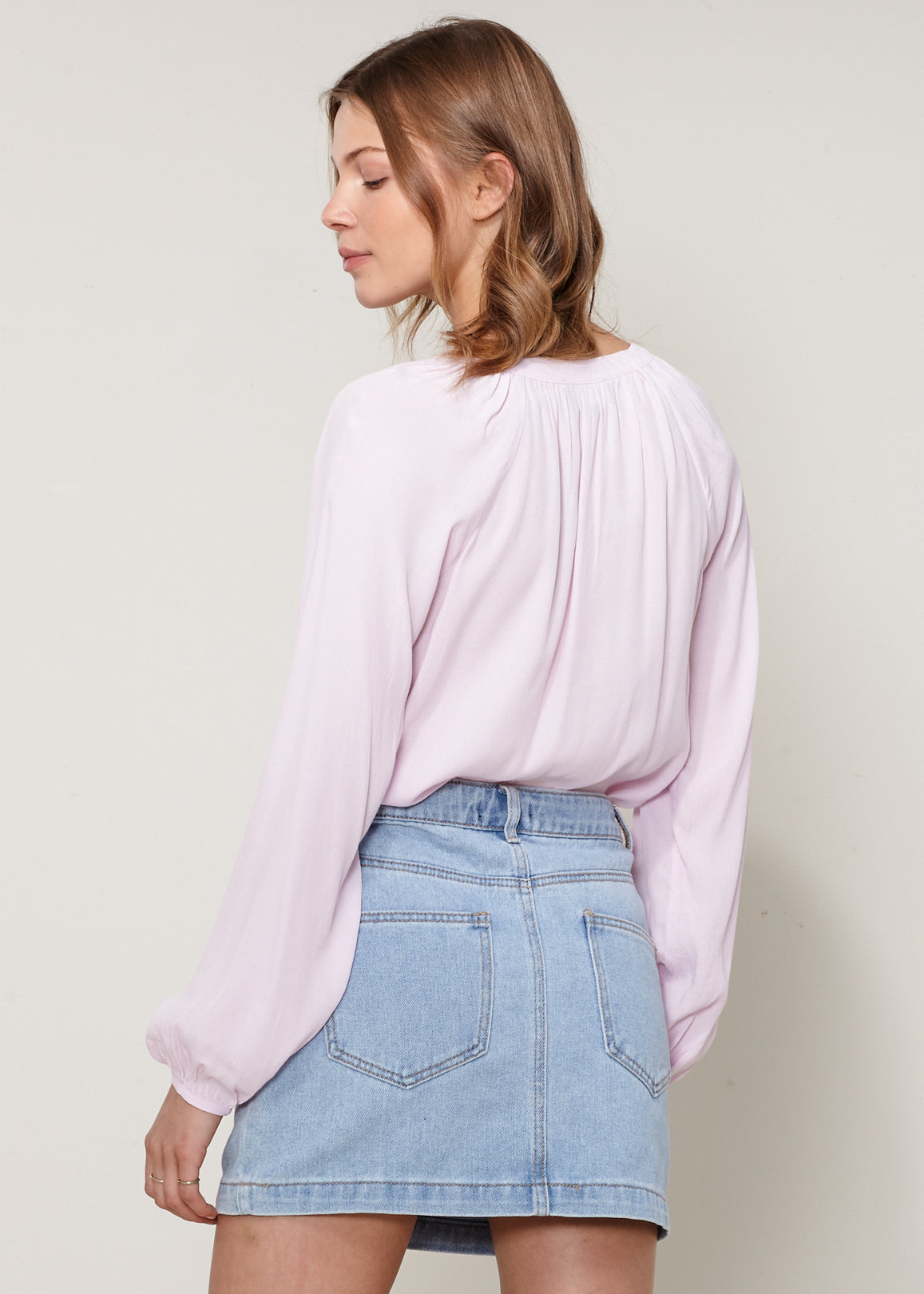 A stylish Women's Lace Up Blouse featuring a round split neck, self-tie lace-up front, and long sleeves with gathered cuffs, made from 100% viscose.
