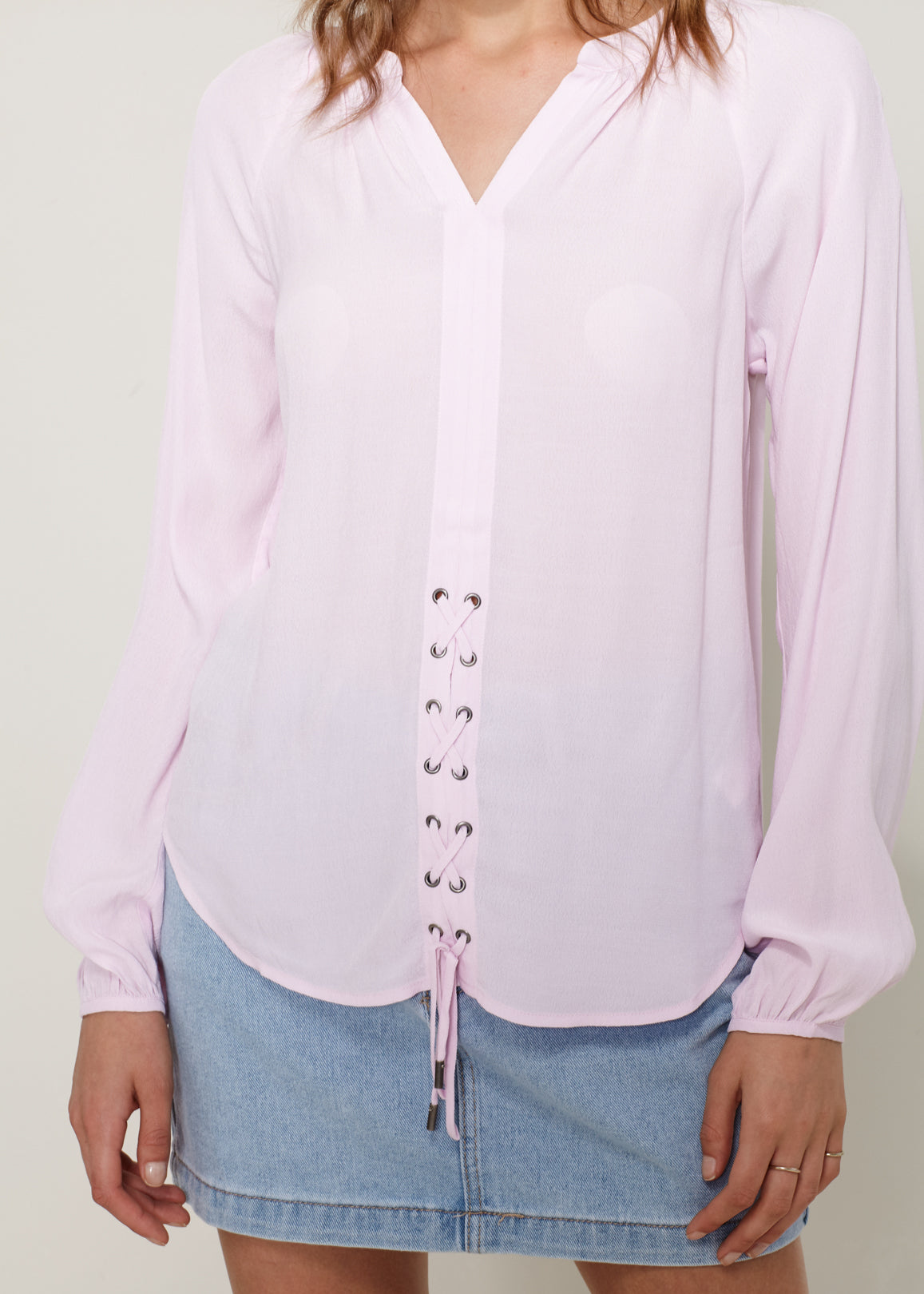 A stylish Women's Lace Up Blouse featuring a round split neck, self-tie lace-up front, and long sleeves with gathered cuffs, made from 100% viscose.