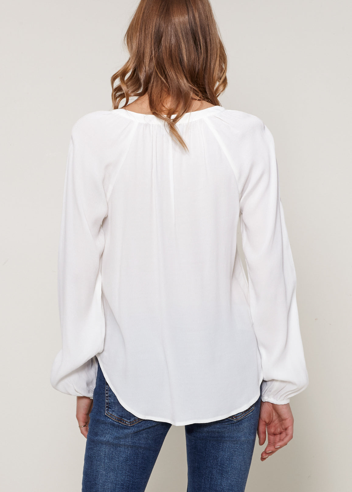 A stylish Women's Lace Up Blouse featuring a round split neck, self-tie lace-up front, and long sleeves with gathered cuffs, made from 100% viscose.