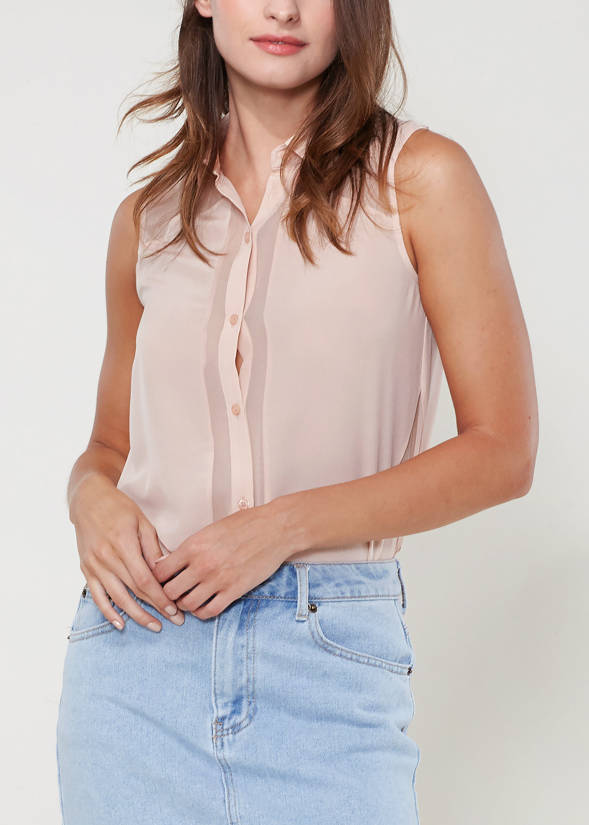 A stylish women's sleeveless button shirt made of 100% silk, featuring a soft texture and sheer look, perfect for various occasions.