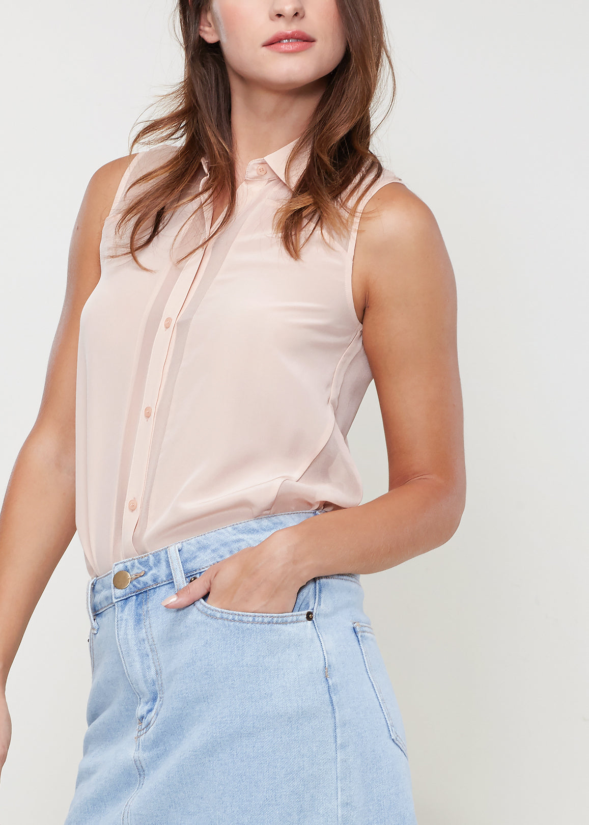 A stylish women's sleeveless button shirt made of 100% silk, featuring a soft texture and sheer look, perfect for various occasions.