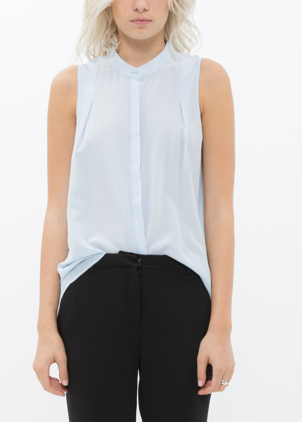 A stylish women's sleeveless mock neck sheer blouse made of 100% silk, featuring a button closure and elegant design.