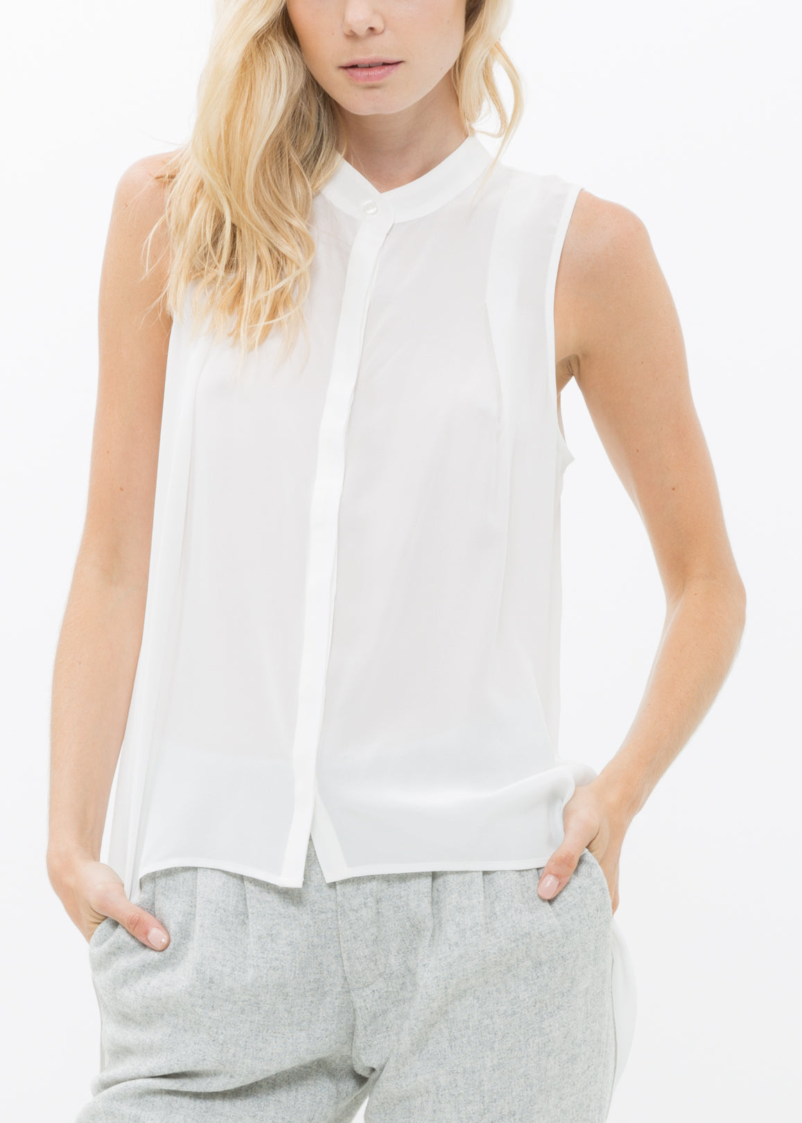 A stylish women's sleeveless mock neck sheer blouse made of 100% silk, featuring a button closure and elegant design.