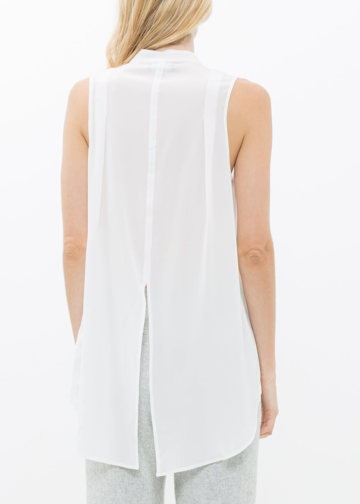 A stylish women's sleeveless mock neck sheer blouse made of 100% silk, featuring a button closure and elegant design.