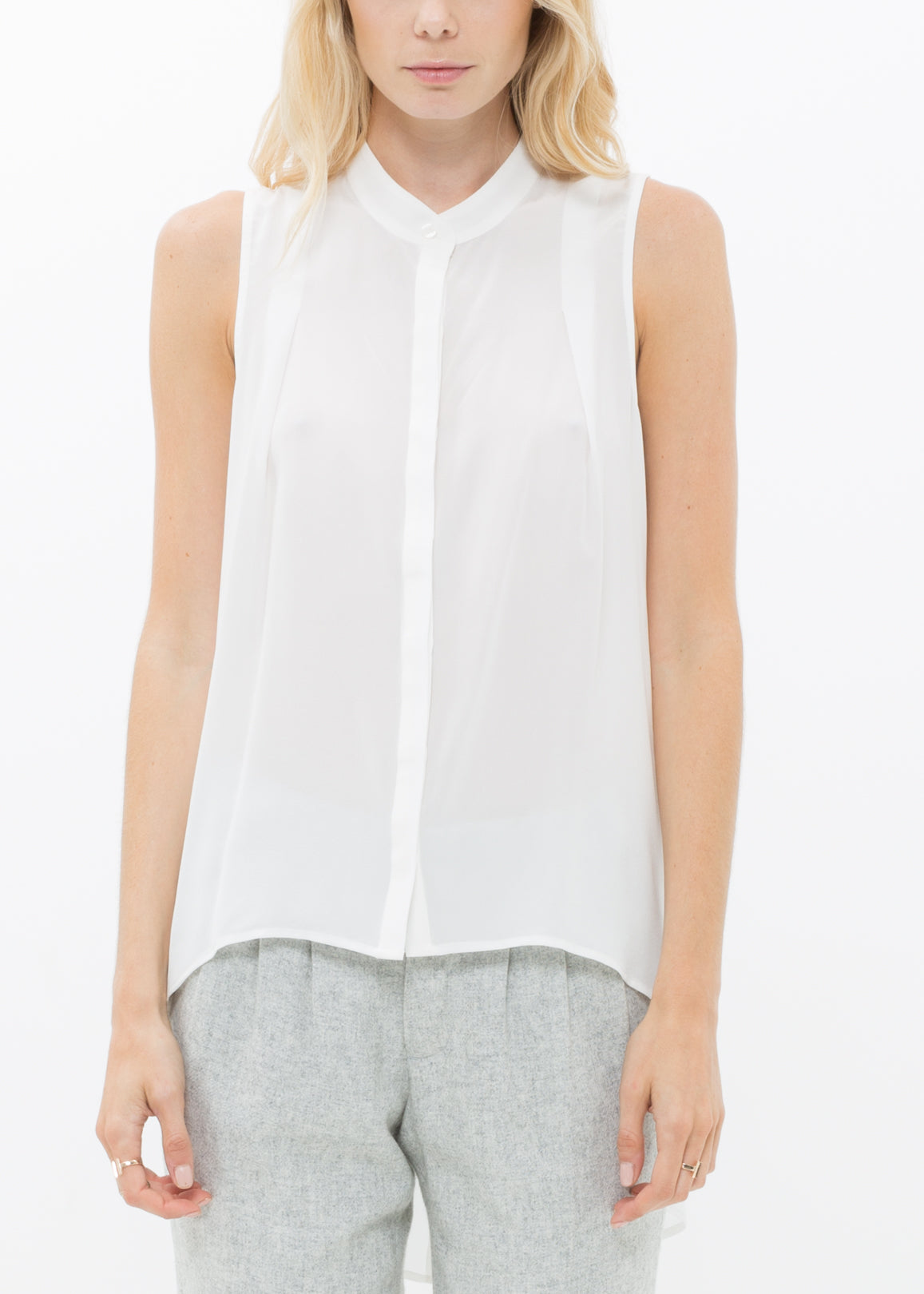 A stylish women's sleeveless mock neck sheer blouse made of 100% silk, featuring a button closure and elegant design.