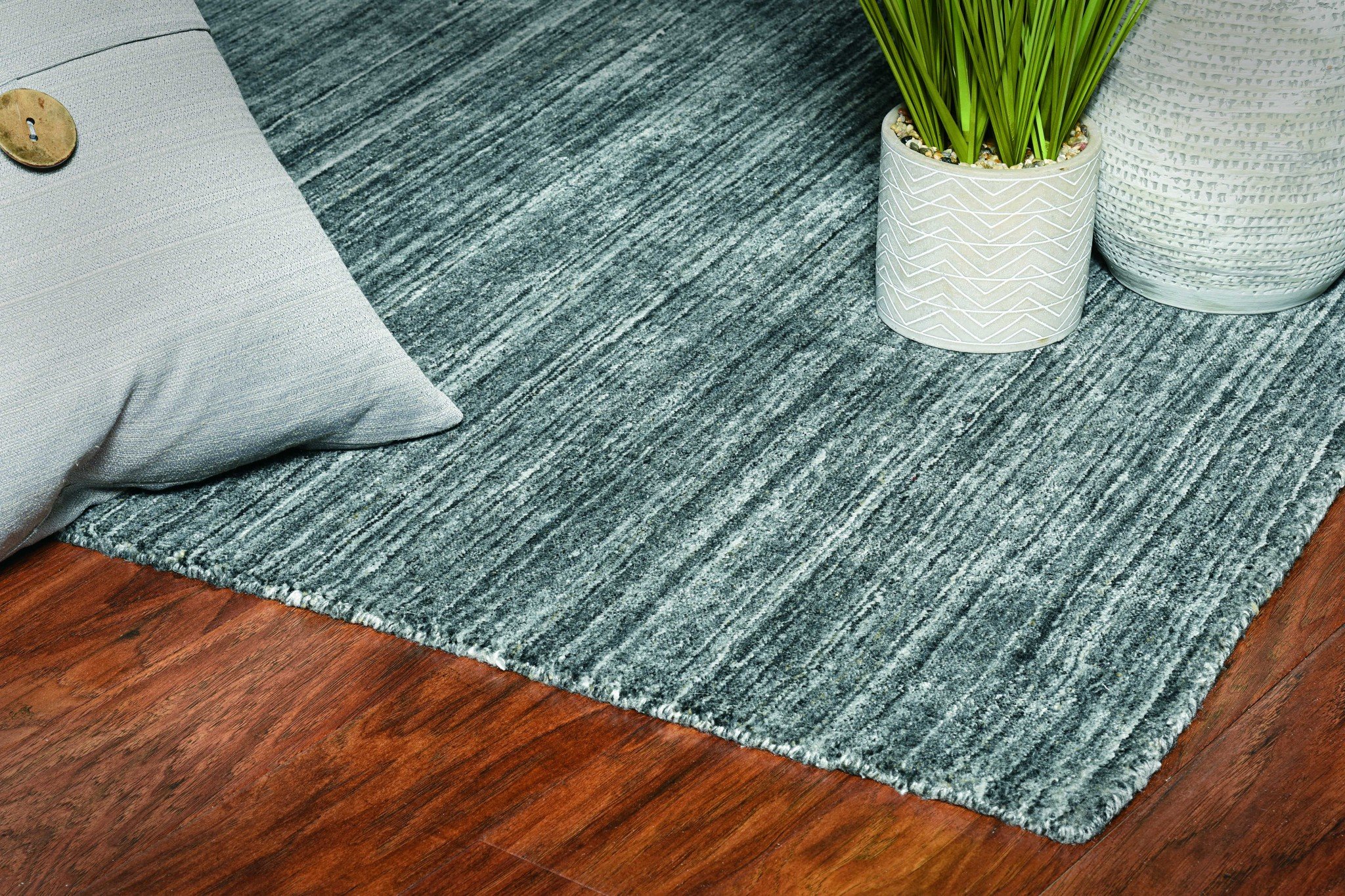 A large 108" x 144" Charcoal Pet Yarn Rug, hand-loomed in India, featuring a soft texture and knotted backing, perfect for various home decor styles.