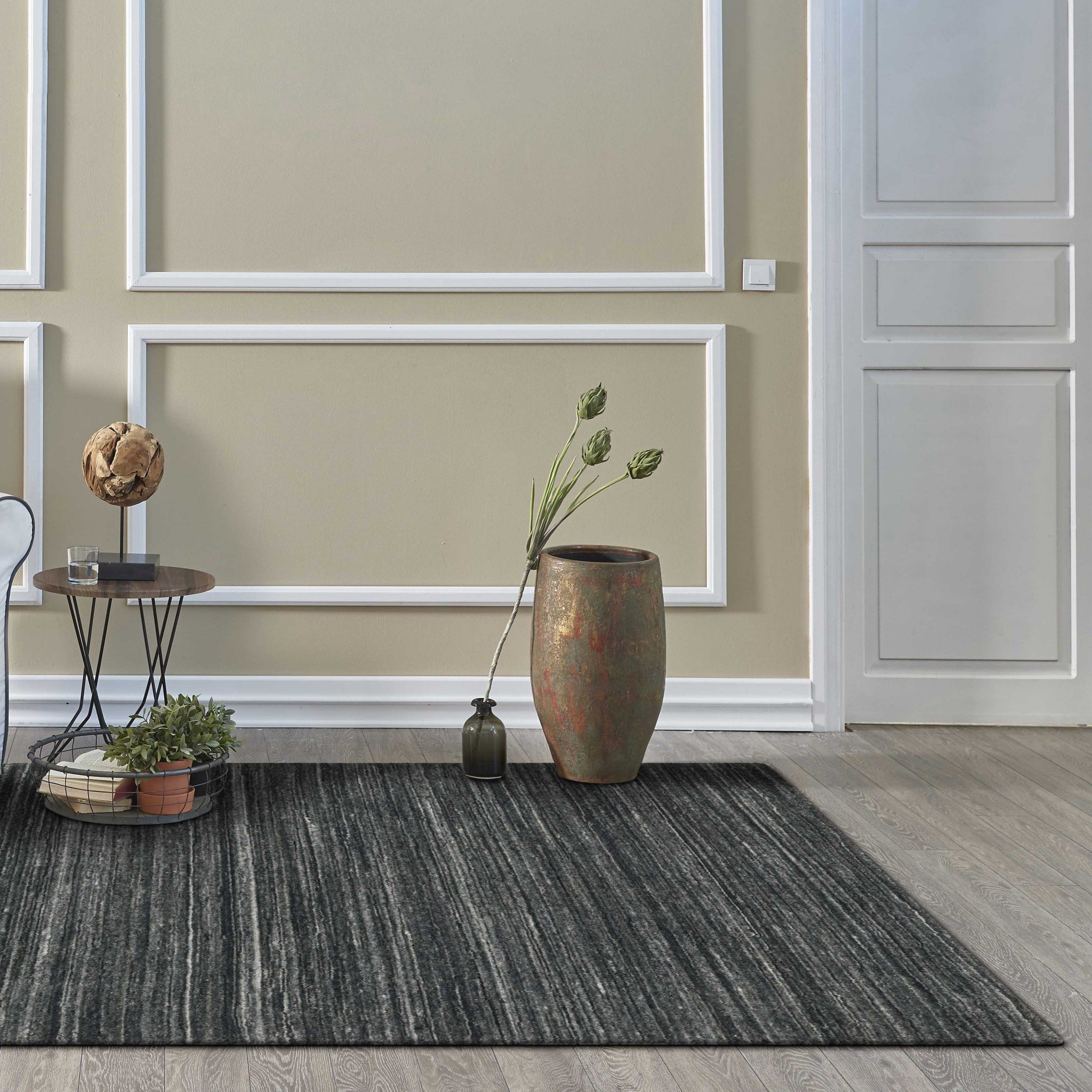 A large 108" x 144" Charcoal Pet Yarn Rug, hand-loomed in India, featuring a soft texture and knotted backing, perfect for various home decor styles.