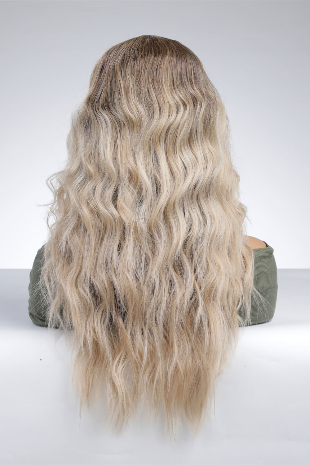A mannequin displaying a 13*2'' lace front wig with long wavy synthetic hair, showcasing its natural look and 150% density.