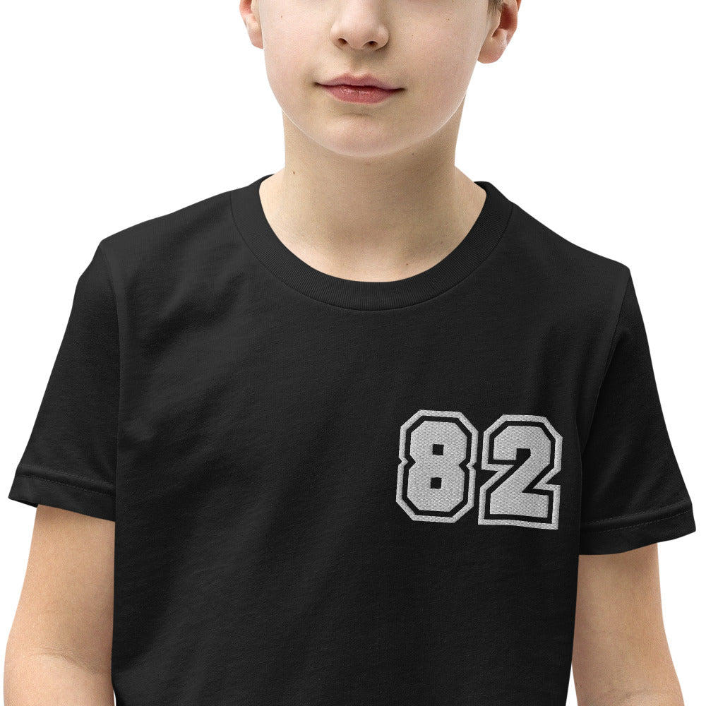 A youth short sleeve t-shirt featuring the unique 'Greeky Prepster 82' design, made from soft cotton fabric, perfect for kids.