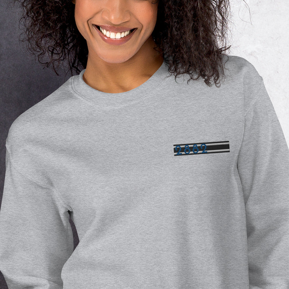2882Sport™ Tropics Of OZ embroidered sweatshirt in a cozy setting, showcasing its soft fabric and classic fit.