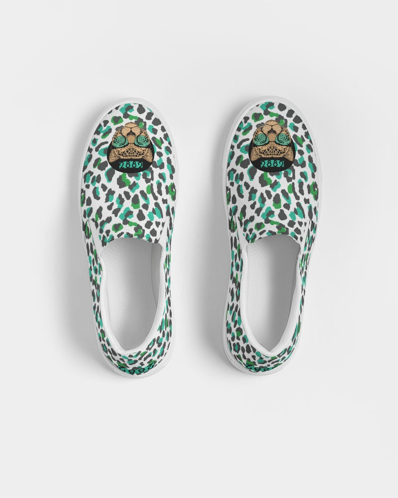 2882Sport™ Tropics of Oz Men's Cheetah Slip-On Canvas Shoes featuring a vibrant cheetah print and Shady Lion graphic.