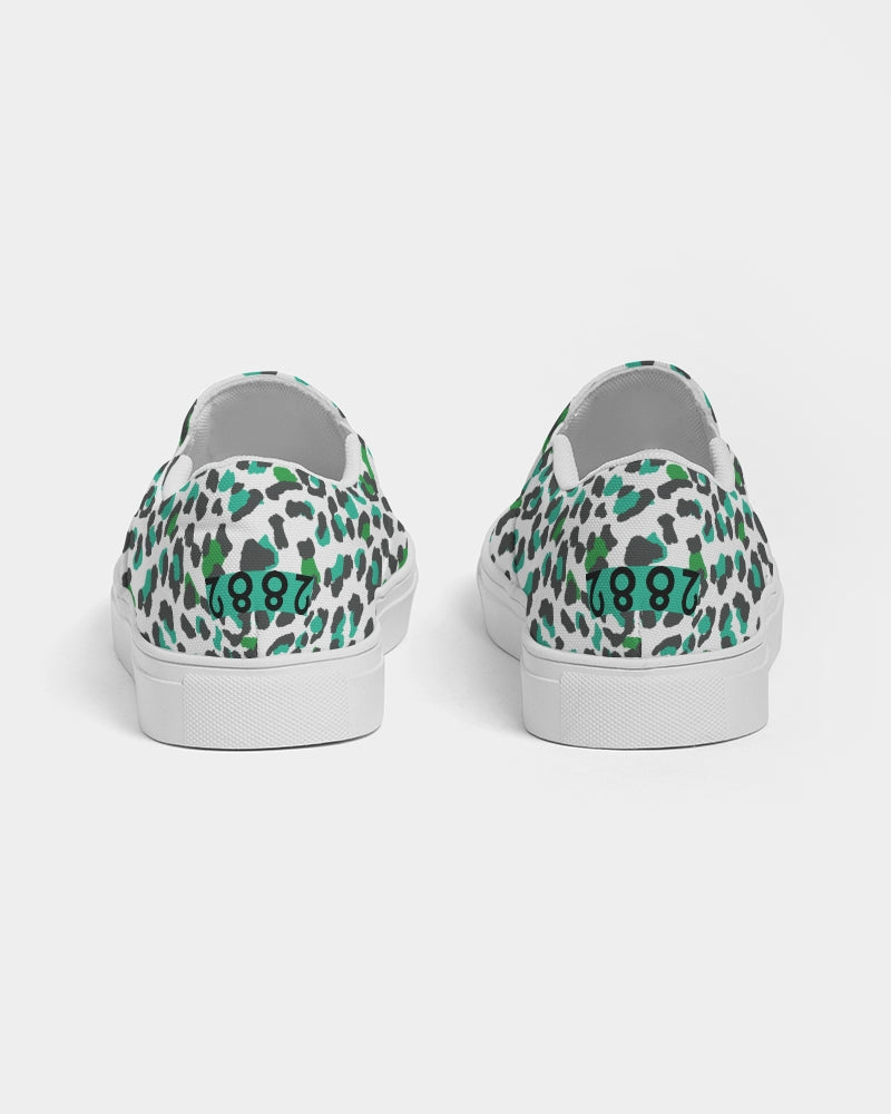 2882Sport™ Tropics of Oz Men's Cheetah Slip-On Canvas Shoes featuring a vibrant cheetah print and Shady Lion graphic.