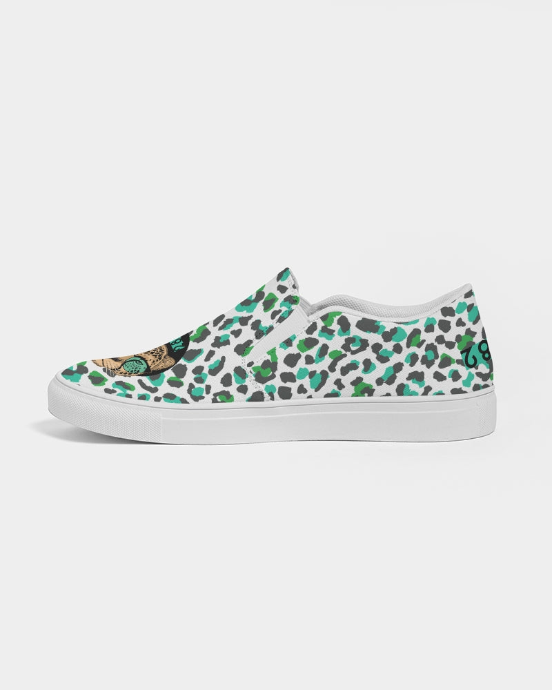 2882Sport™ Tropics of Oz Men's Cheetah Slip-On Canvas Shoes featuring a vibrant cheetah print and Shady Lion graphic.