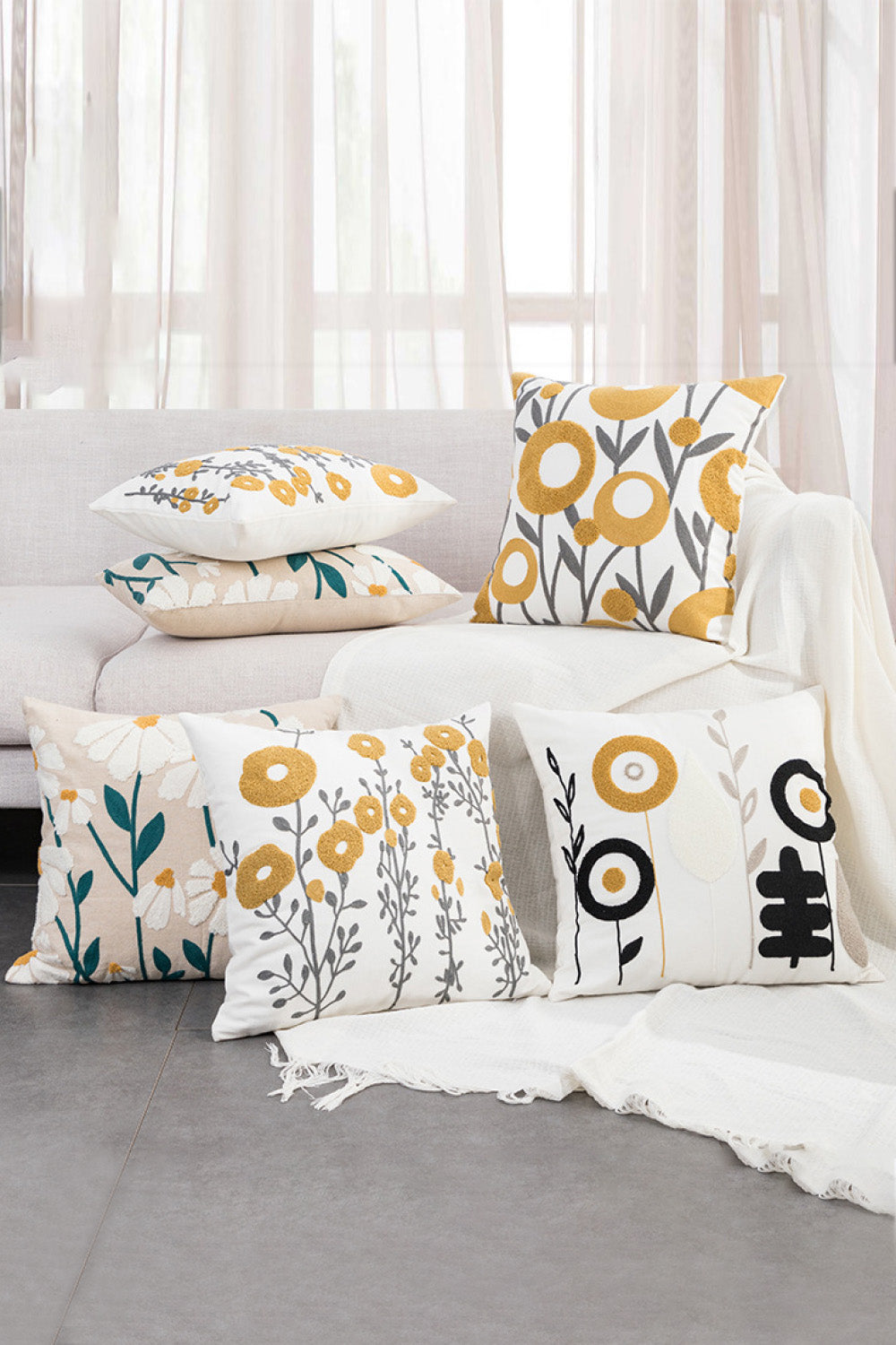 Two decorative throw pillow cases featuring floral punch-needle embroidery design, one rectangular and one square, showcasing vibrant colors.