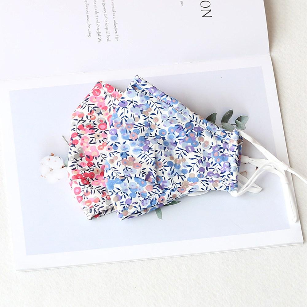 Two stylish Cherry Dream cotton face masks with nose wire and filter pocket, showcasing unique prints and adjustable ear loops.