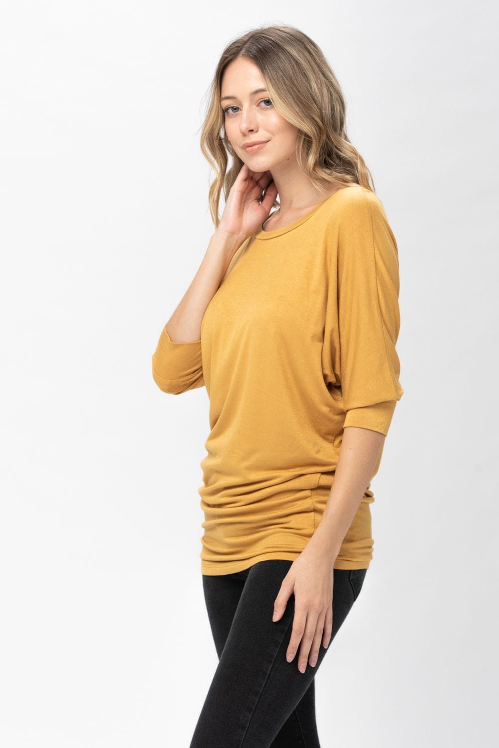A stylish 3/4 dolman batwing sleeve tunic in a soft fabric, featuring a round neck and a loose fit, perfect for casual wear.