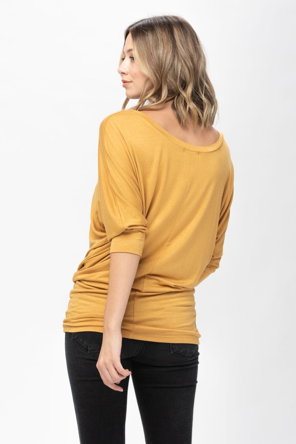 A stylish 3/4 dolman batwing sleeve tunic in a soft fabric, featuring a round neck and a loose fit, perfect for casual wear.