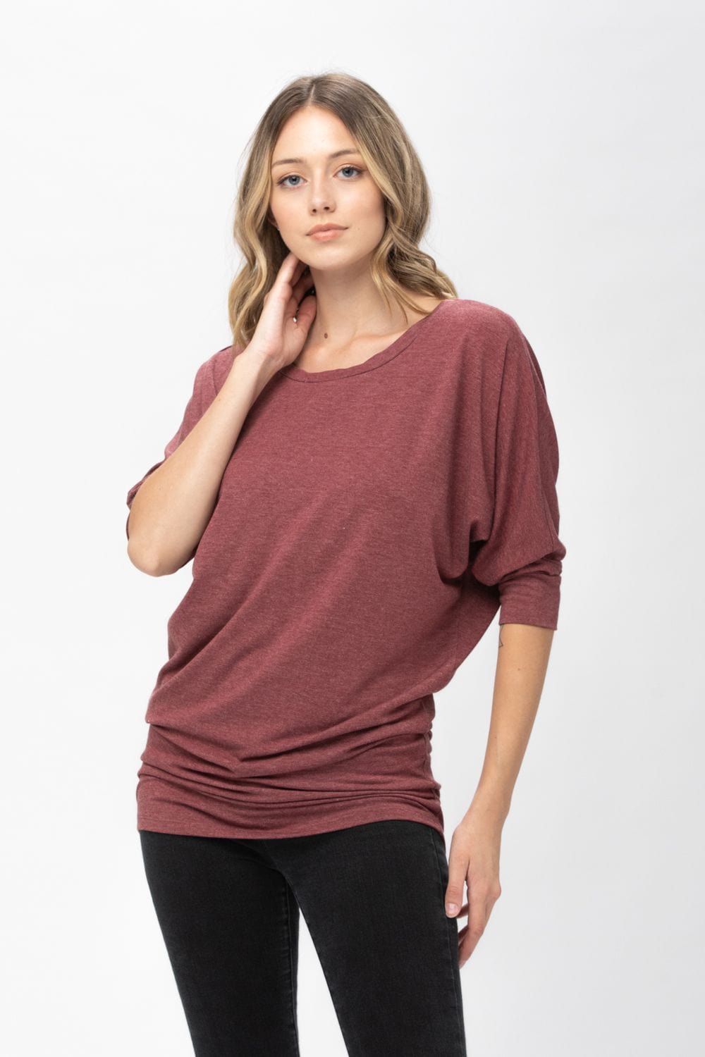 A stylish 3/4 dolman batwing sleeve tunic in a soft fabric, featuring a round neck and a loose fit, perfect for casual wear.