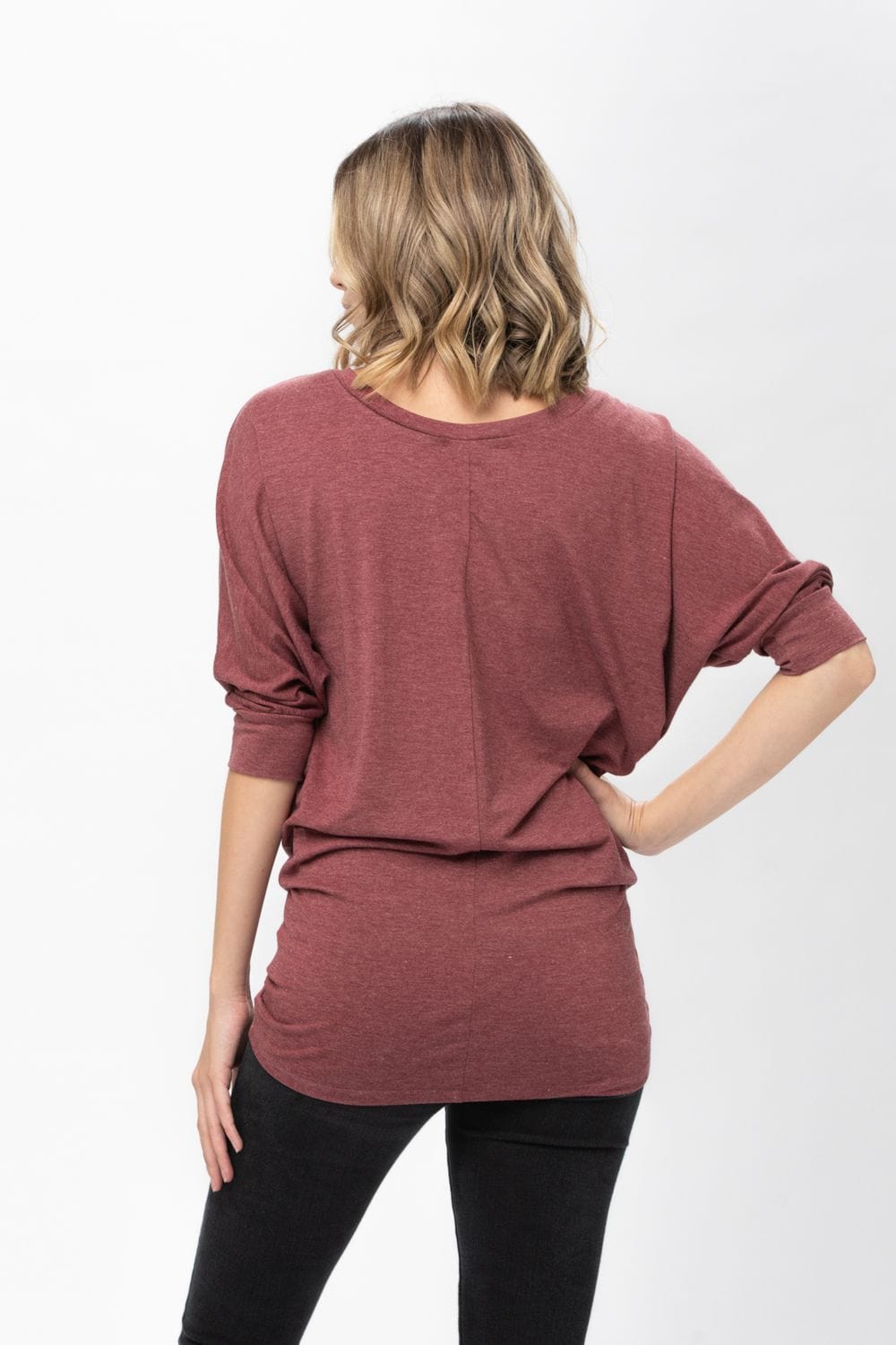 A stylish 3/4 dolman batwing sleeve tunic in a soft fabric, featuring a round neck and a loose fit, perfect for casual wear.