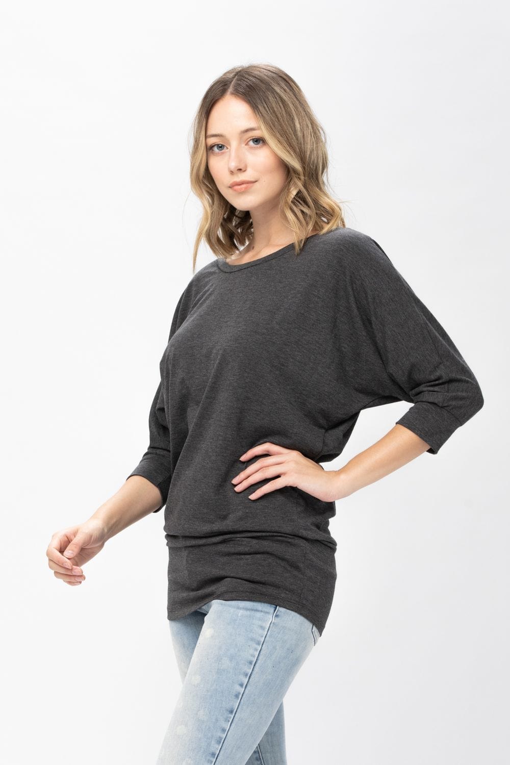 A stylish 3/4 dolman batwing sleeve tunic in a soft fabric, featuring a round neck and a loose fit, perfect for casual wear.