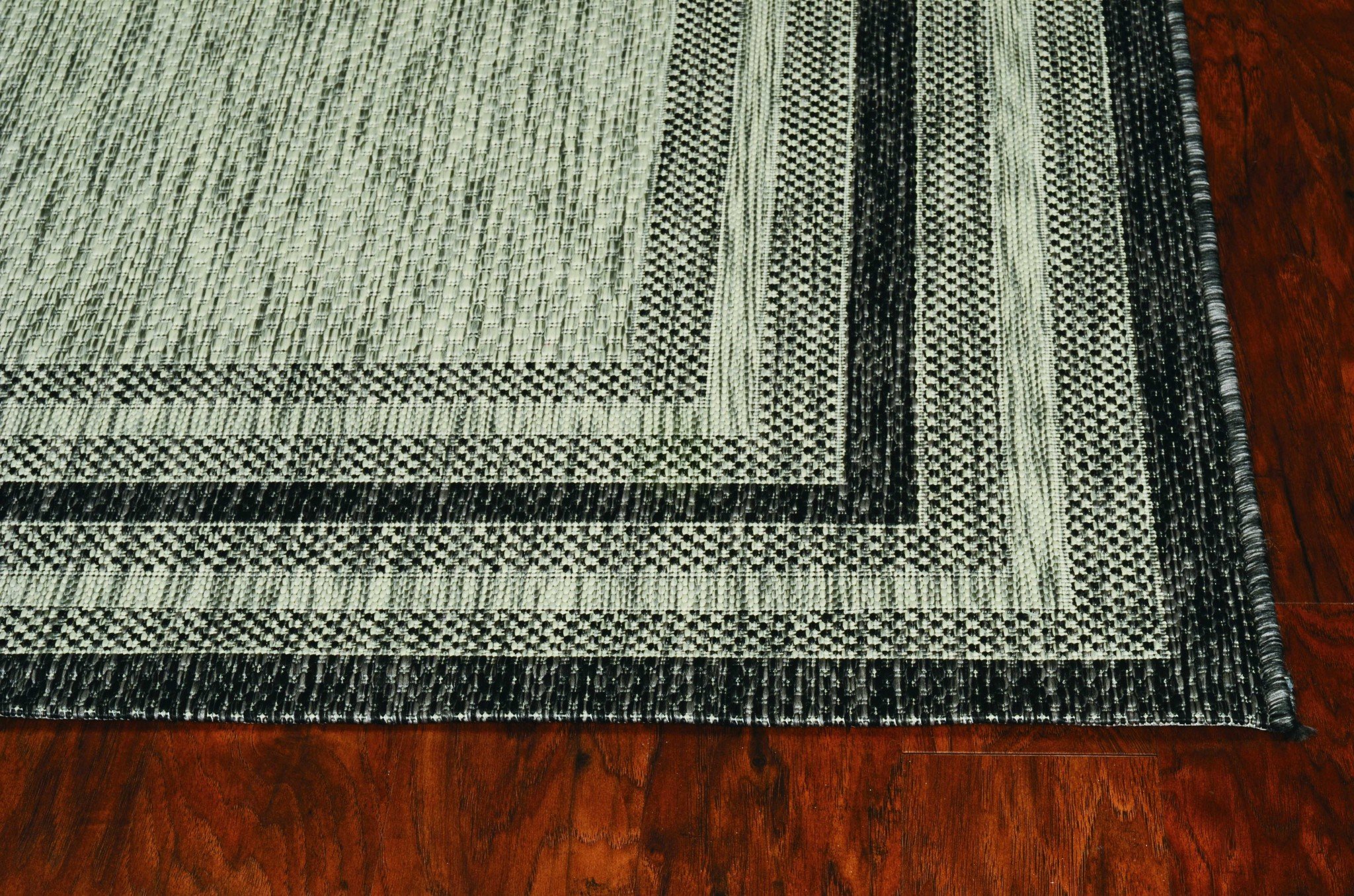 3x4 inches grey machine woven UV treated bordered indoor outdoor rug with textured patterns and vibrant colors.