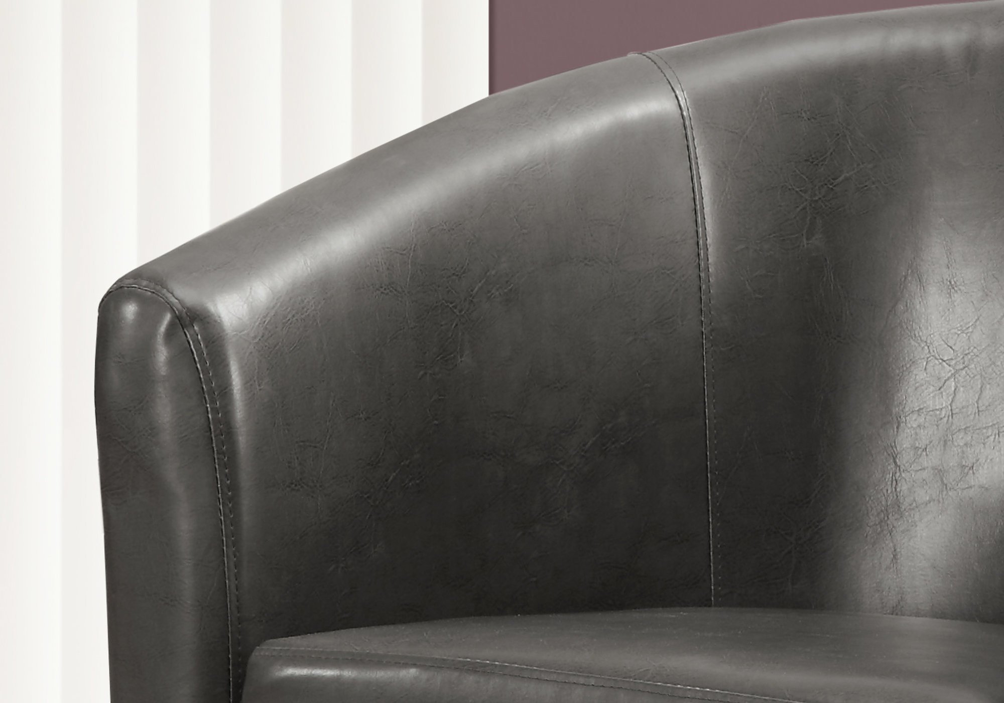 Stylish charcoal black leather-look foam accent chair with elegant design and comfortable seating.