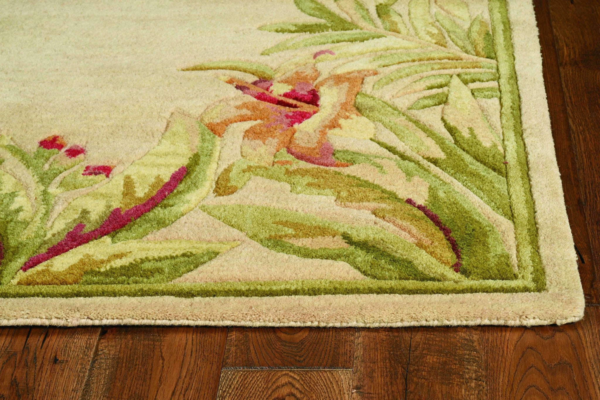 Ivory hand-tufted bordered tropical plant indoor area rug, showcasing floral patterns and a modern design.