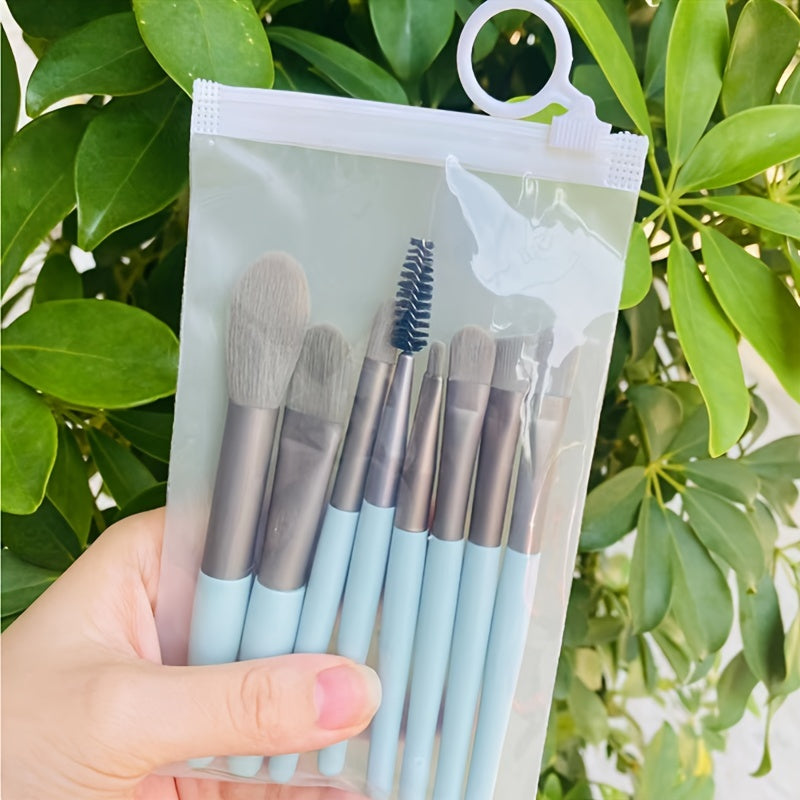 8-piece portable makeup brush set with soft nylon bristles, ideal for travel and makeup application.