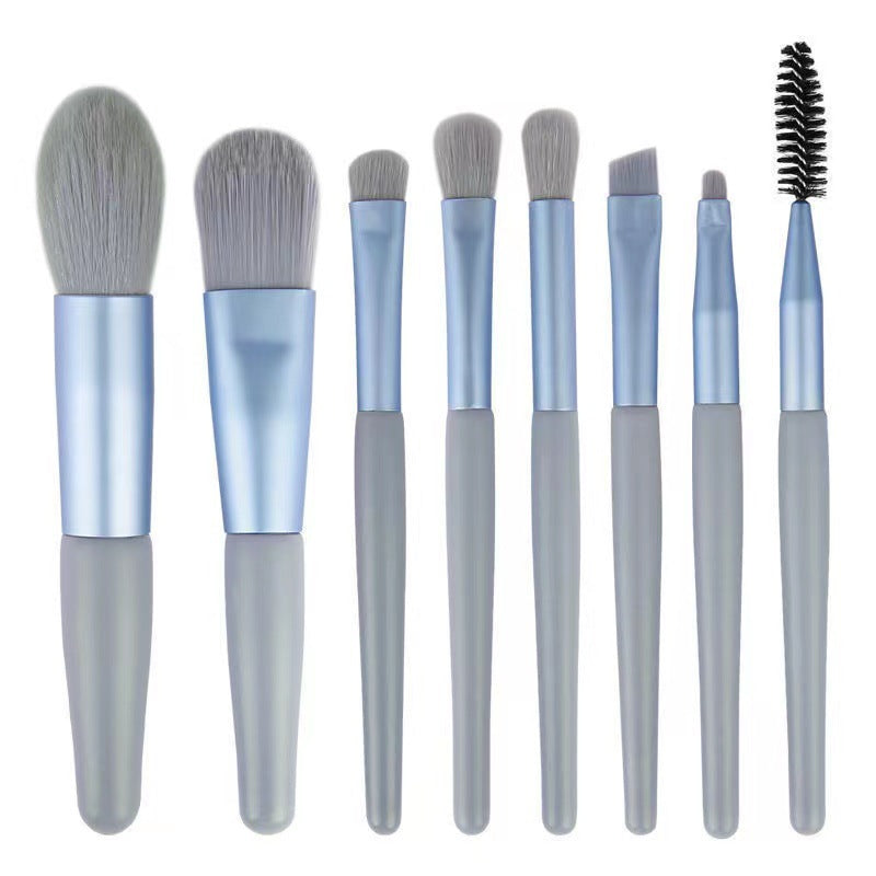 8-piece portable makeup brush set with soft nylon bristles, ideal for travel and makeup application.