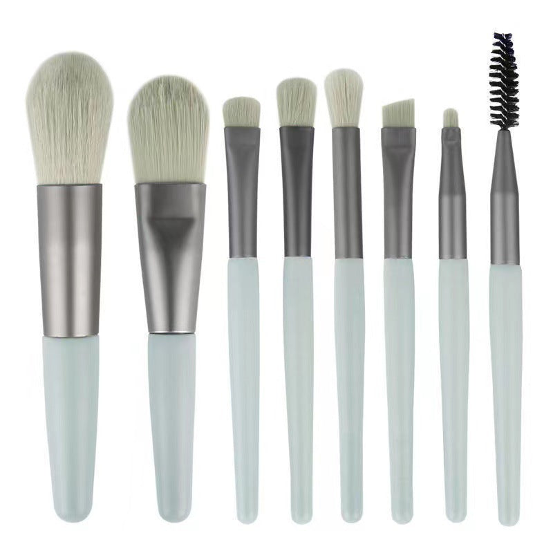 8-piece portable makeup brush set with soft nylon bristles, ideal for travel and makeup application.