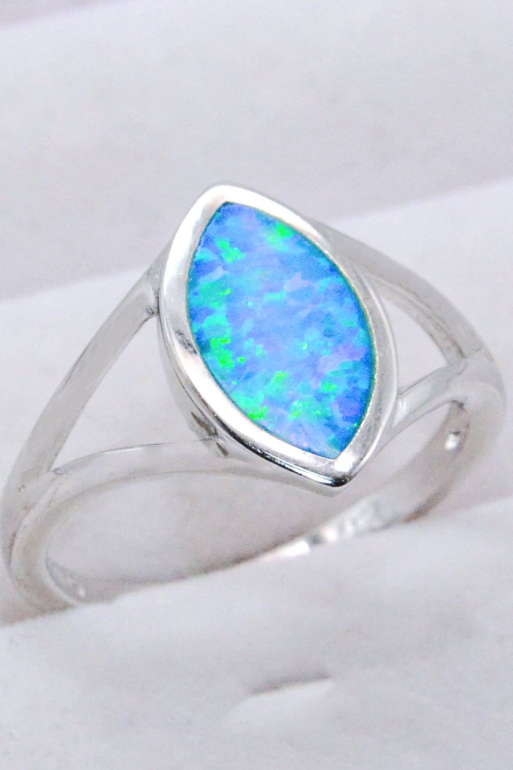 A stunning 925 sterling silver split shank opal ring with a minimalist design, featuring a vibrant opal gemstone.