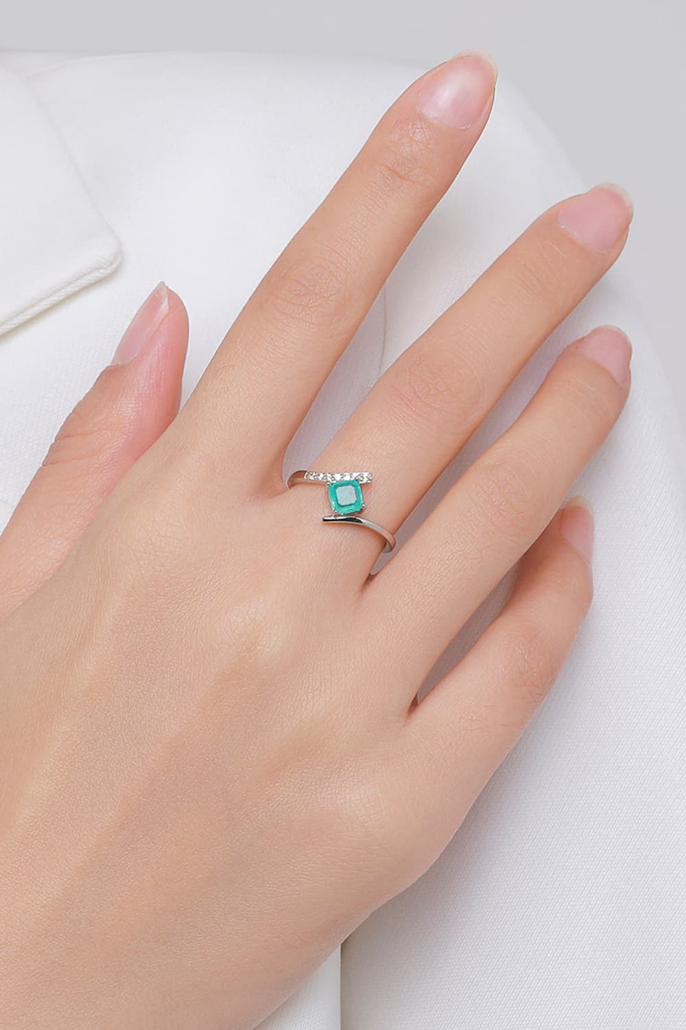 A minimalist 925 sterling silver square shape ring featuring a vibrant tourmaline stone, elegantly displayed on a soft background.