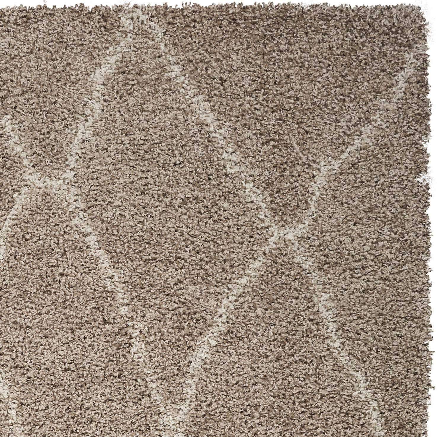 A large 94" x 126" sand-colored shag polypropylene rug with a diamond pattern, perfect for home decor.