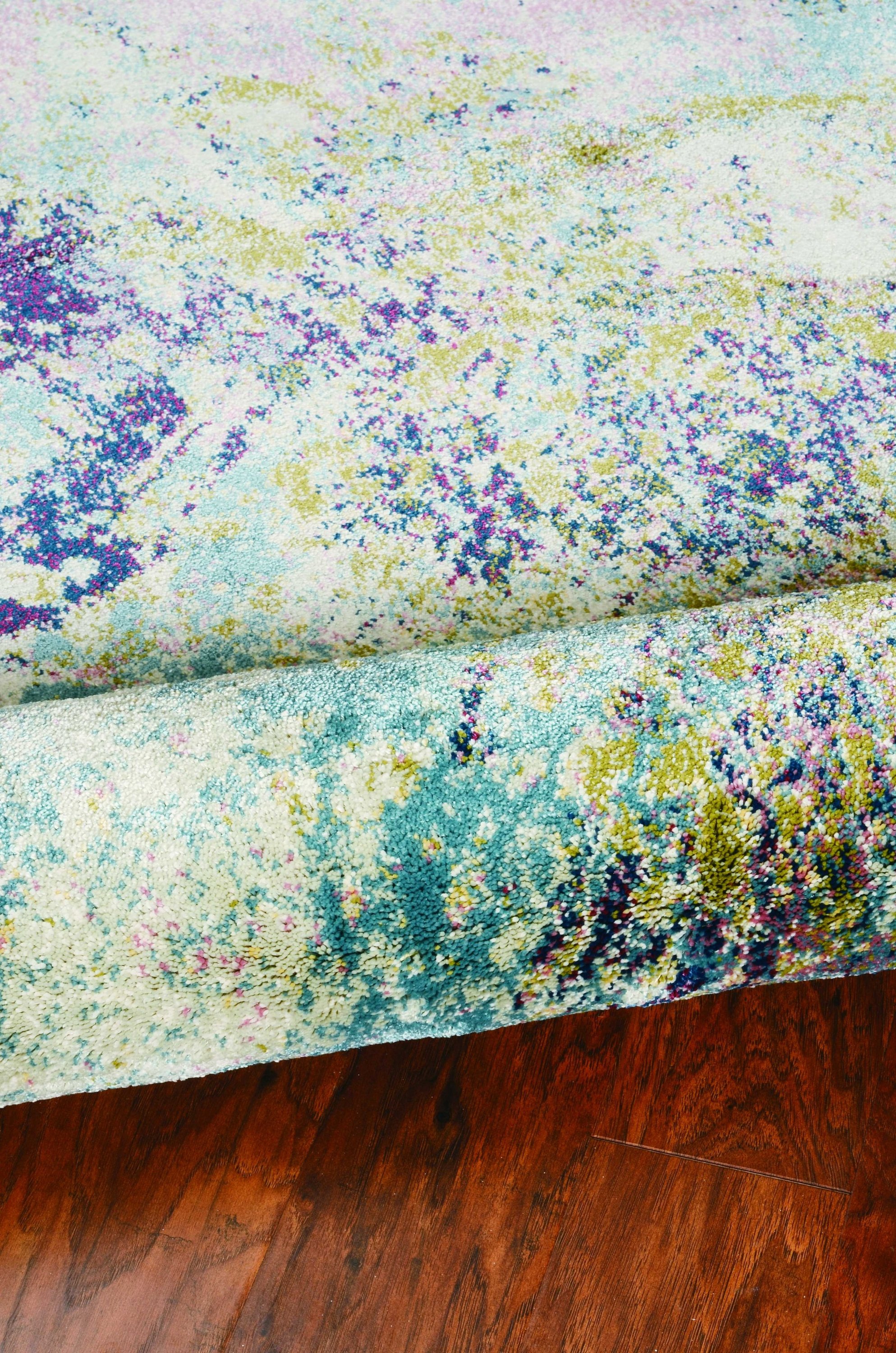 A large 94" x 134" seafoam polypropylene rug featuring a vintage traditional design with distressed touches, perfect for home decor.