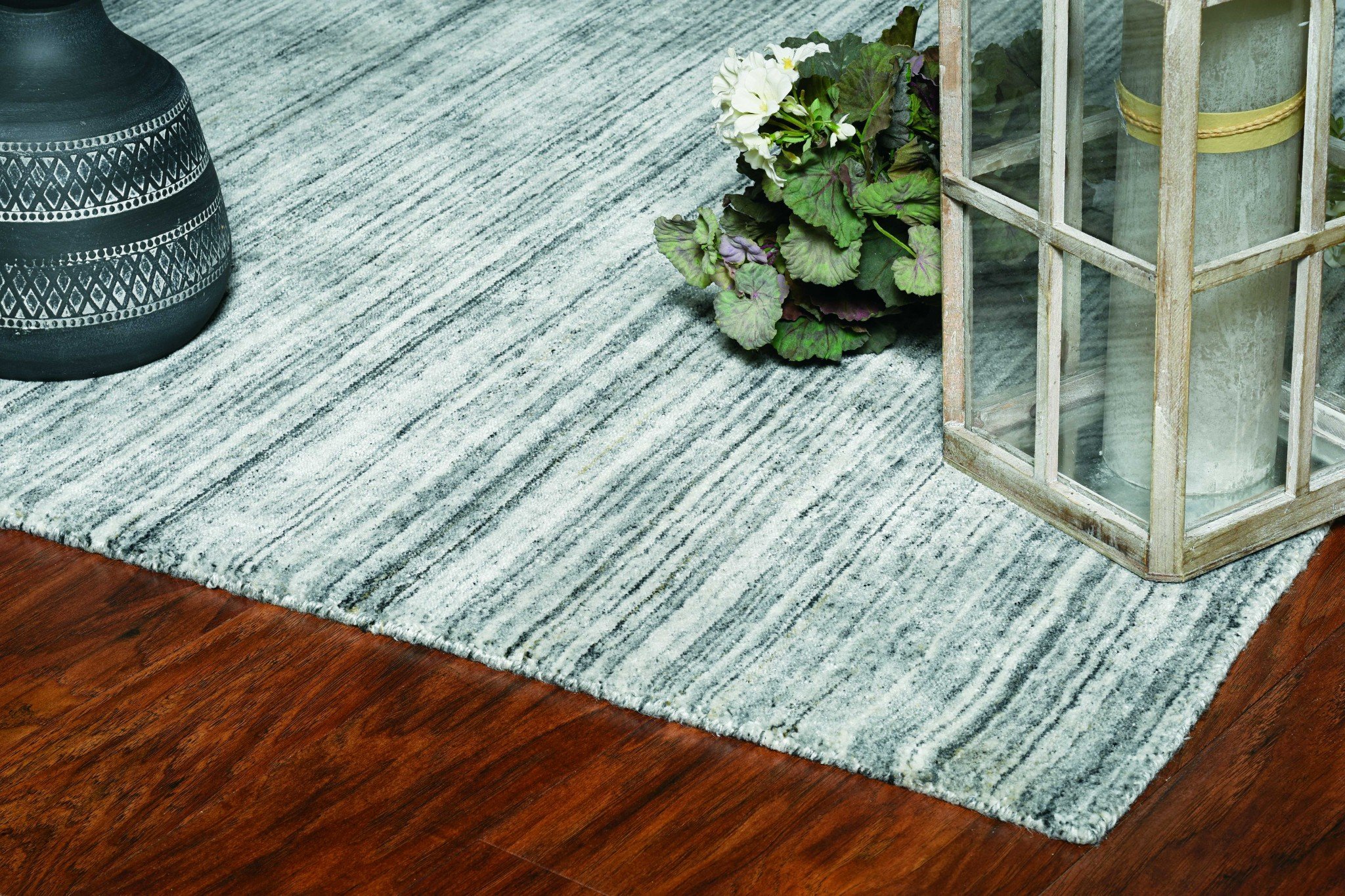 A 96" X 120" Grey Pet Yarn Rug, handloomed in India, showcasing a soft texture and knotted backing, perfect for various home decor styles.