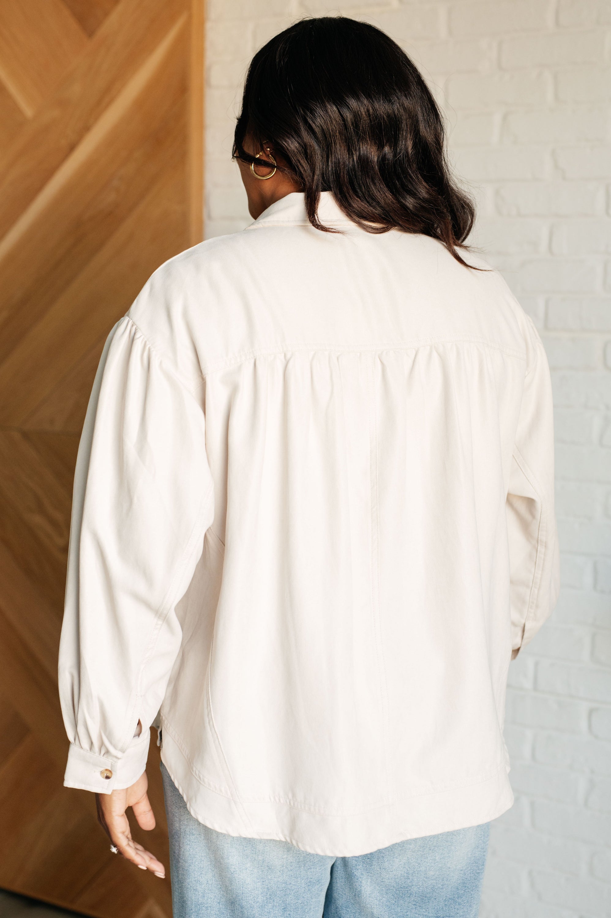 A stylish A Helping Hand Button Up Blouse featuring faux suede fabric, collared neckline, and long bishop sleeves.