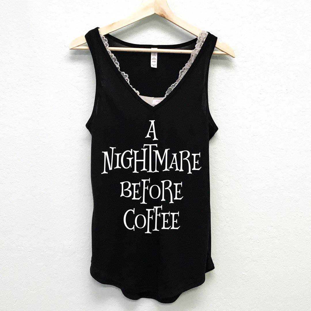 A black V-neck tank top with the phrase 'A Nightmare Before Coffee' printed on it, showcasing a stylish and casual design.