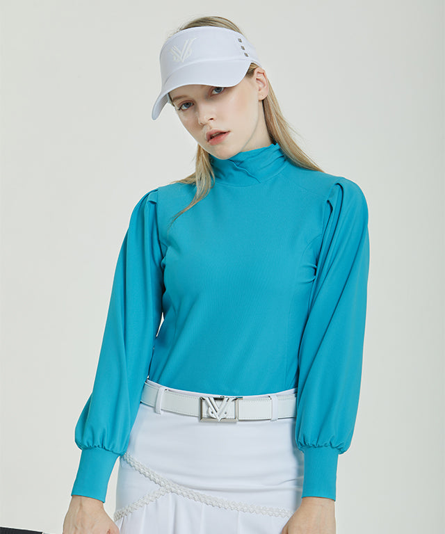 Abel Golgi Half Turtle in Mint color with luxurious ribbed texture and feminine puff sleeves, displayed on a model.