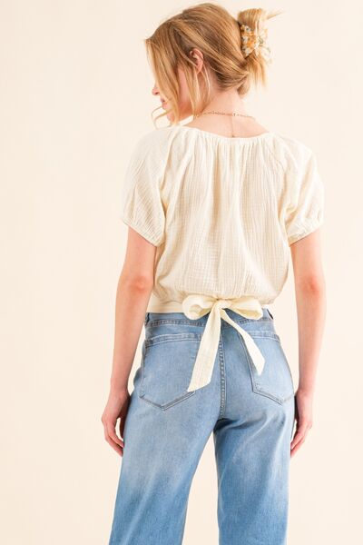 And The Why Cotton Gauze Back Waist Tie Cropped Blouse in a stylish design, showcasing the unique back waist tie and lightweight fabric.