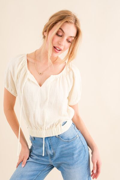 And The Why Cotton Gauze Back Waist Tie Cropped Blouse in a stylish design, showcasing the unique back waist tie and lightweight fabric.