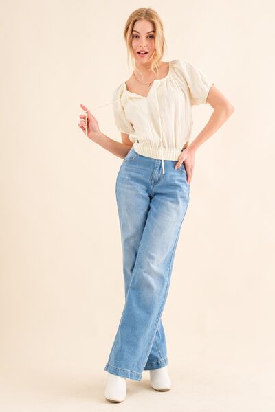 And The Why Cotton Gauze Back Waist Tie Cropped Blouse in a stylish design, showcasing the unique back waist tie and lightweight fabric.