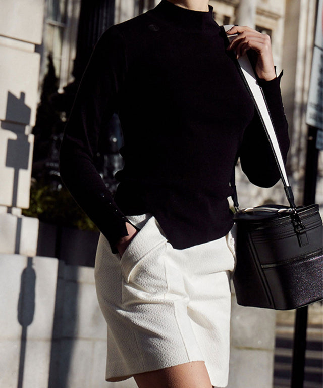 Anell Golf Classic Slim Knit Top in Black featuring a turtleneck and diagonal design details.