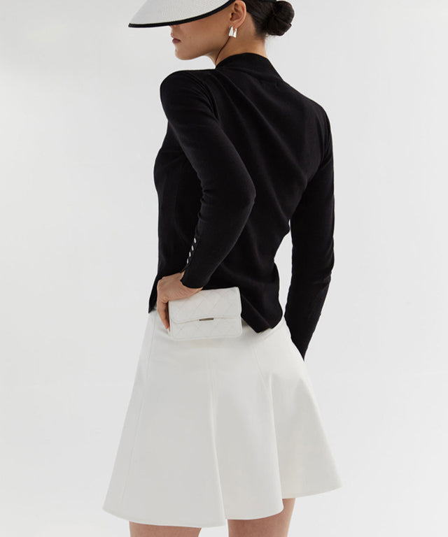 Anell Golf Classic Slim Knit Top in Black featuring a turtleneck and diagonal design details.