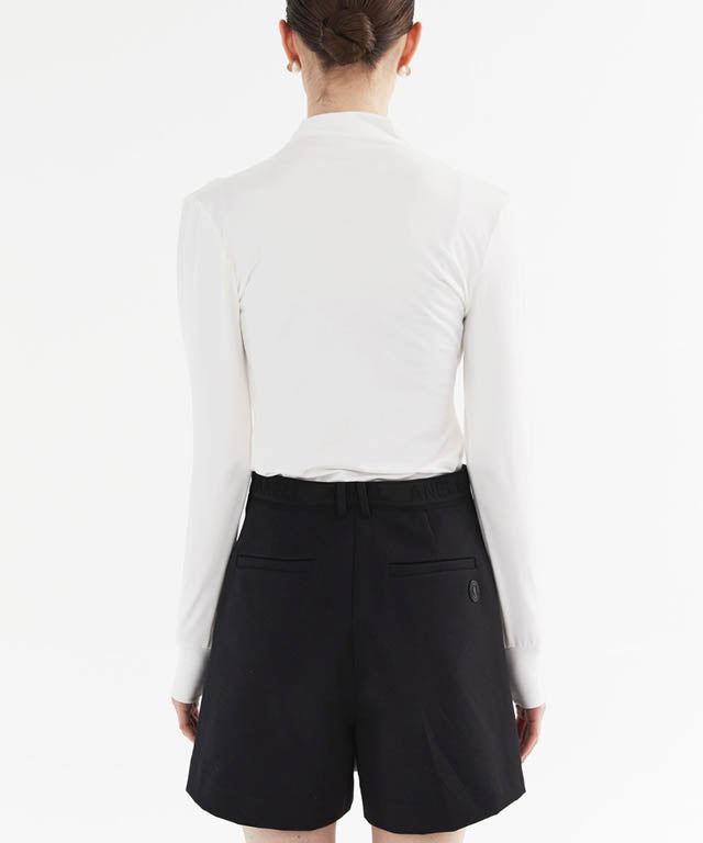 Anell Golf Cotton Wrap Skirt Pants in Black, showcasing a stylish semi-A-line design with a diagonal slit for a flattering fit.