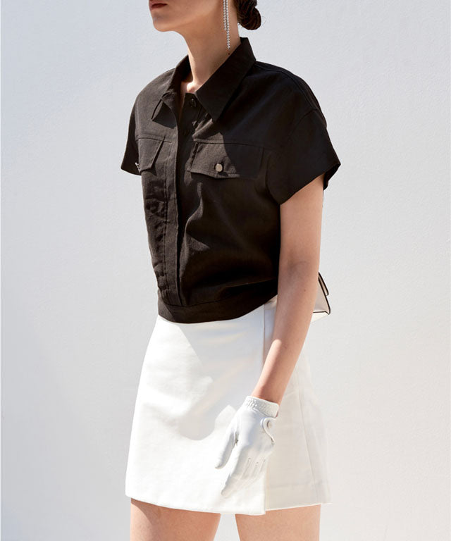 Anell Golf Cotton Wrap Skirt Pants in Black, showcasing a stylish semi-A-line design with a diagonal slit for a flattering fit.