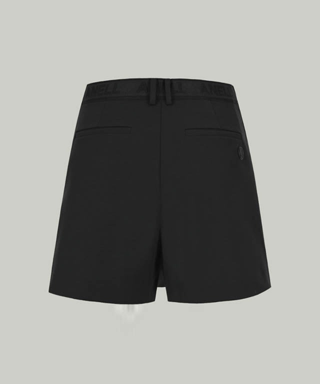 Anell Golf Cotton Wrap Skirt Pants in Black, showcasing a stylish semi-A-line design with a diagonal slit for a flattering fit.