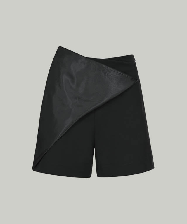 Anell Golf Cotton Wrap Skirt Pants in Black, showcasing a stylish semi-A-line design with a diagonal slit for a flattering fit.